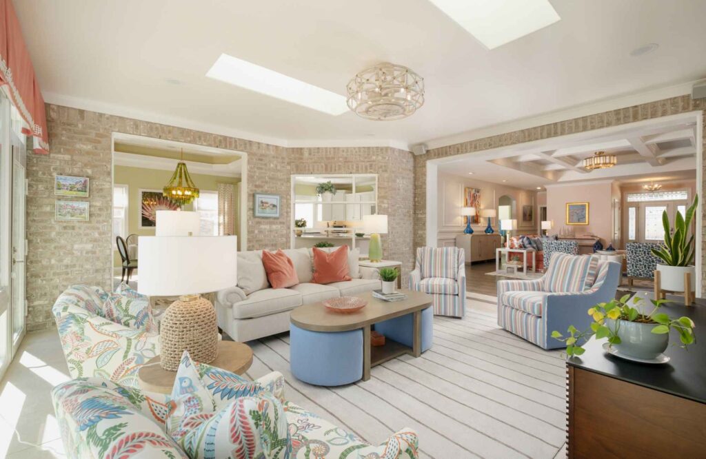 dwelling-place-interiors-brunswick-county-nc-our-design-process-coastal-colorful-living-room-brightly-patterned-chairs-brick-interior-walls-collected-remodel