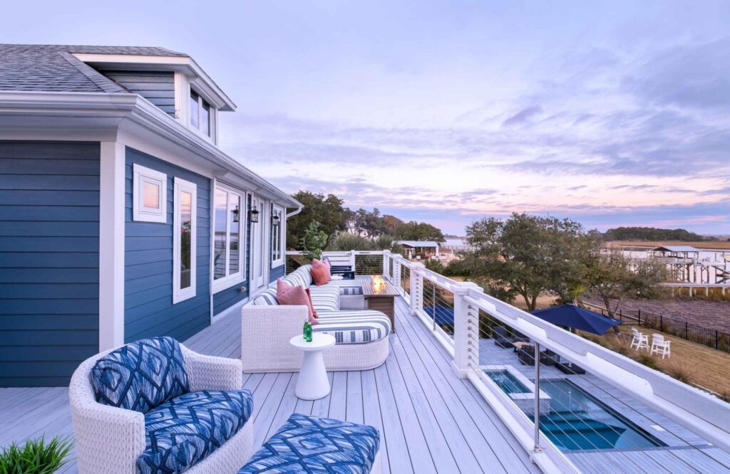 dwelling-place-interiors-new-hanover-nc-our-design-process-second-level-porch-overlooking-waterway-and-pool-outdoor-chairs-blue-cushions-livable-renovation